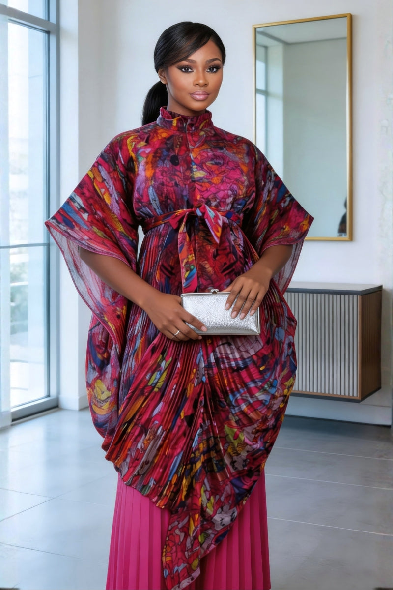 Woman wearing a colorful dress with a pink bottom half in a modern interior setting.