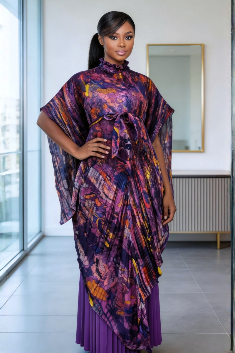 Woman wearing a colorful patterned dress in an indoor setting.