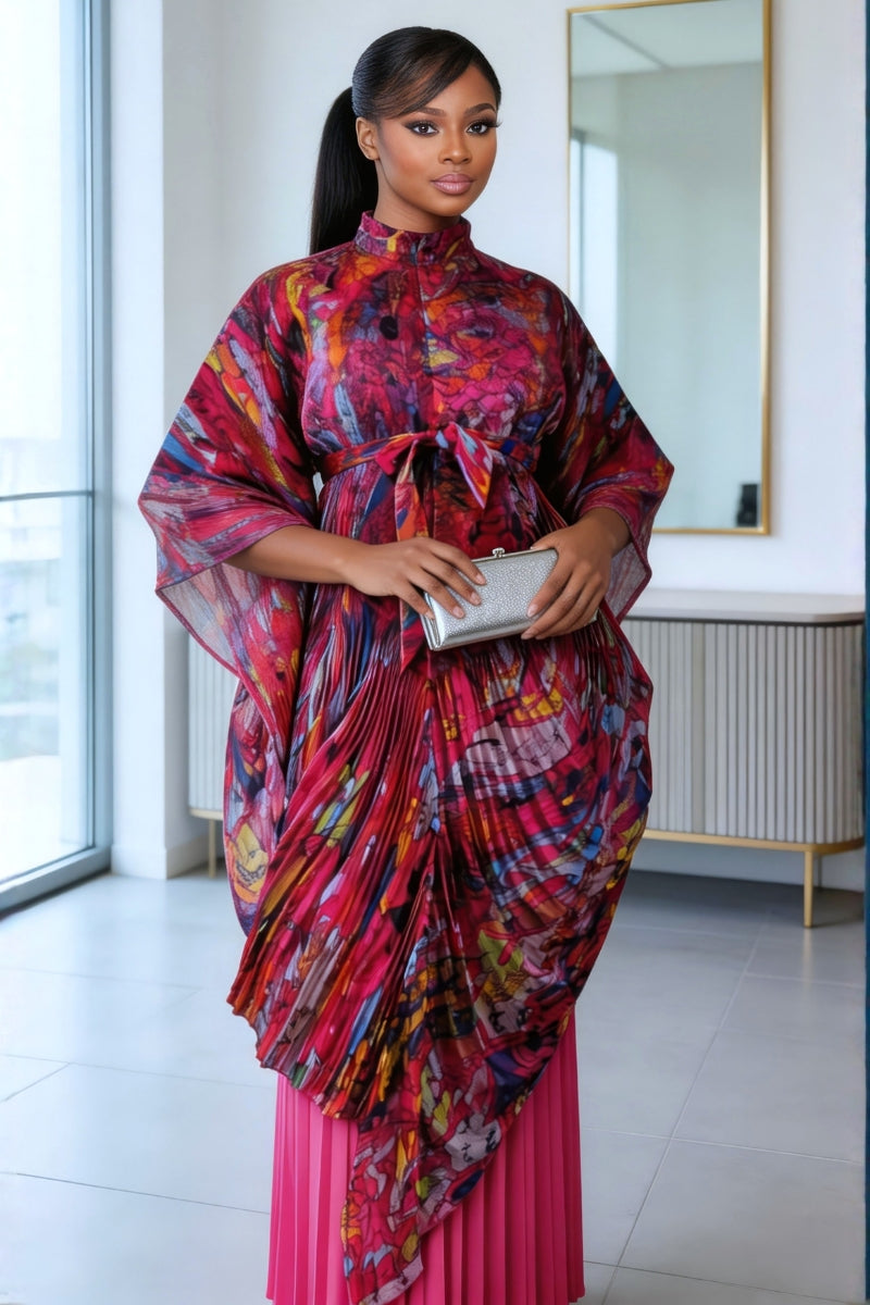 Woman in a colorful dress standing in a room with a mirror.