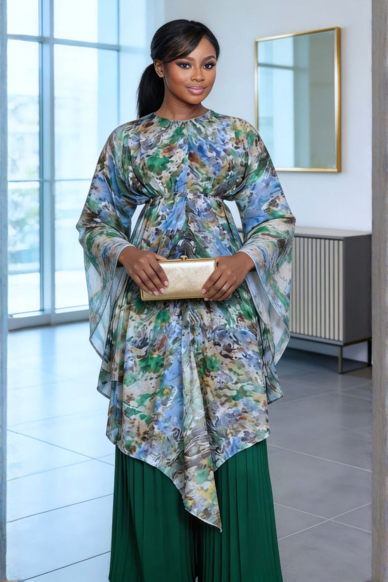 Woman wearing a floral top and green skirt in an indoor setting