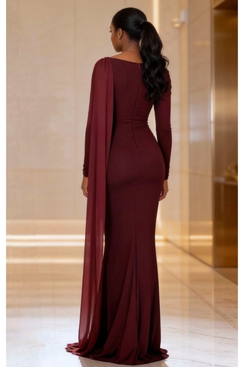 Burgundy evening gown with cape worn by a model in an indoor setting