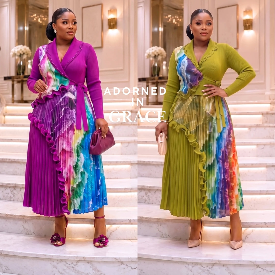 Two women modeling matching long-sleeve wrap-style maxi dresses with pleated ruffle details and a colorful tie-dye lower skirt, posed on white marble stairs in an elegant indoor setting. The dress on the left is magenta and blue, and the dress on the right is olive green and blue; both have multicolor tie-dye panels.
